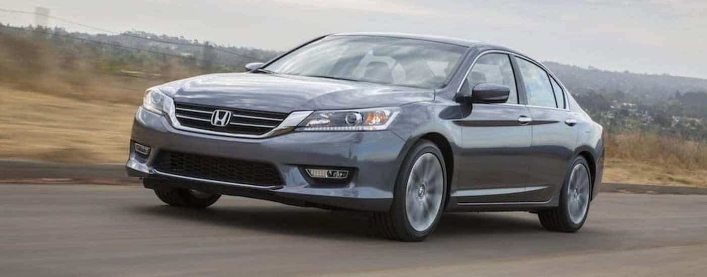 A gray 2013 Honda Accord is shown driving on a road.