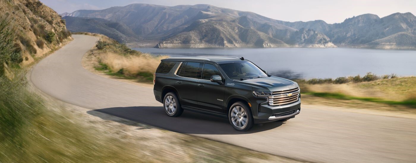 Black 2022 Chevy Tahoe High Country on a winding road.