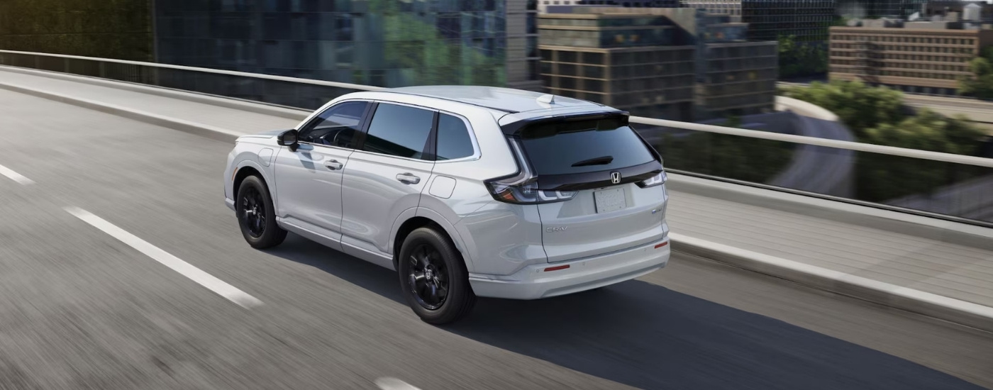 White 2025 Honda CR-V eFCEV driving on a bridge