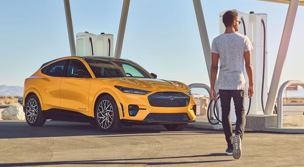 Yellow 2022 Ford Mustang Mach-E GT at a charging station
