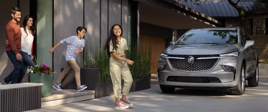 Family walking to their 2024 Buick Enclave