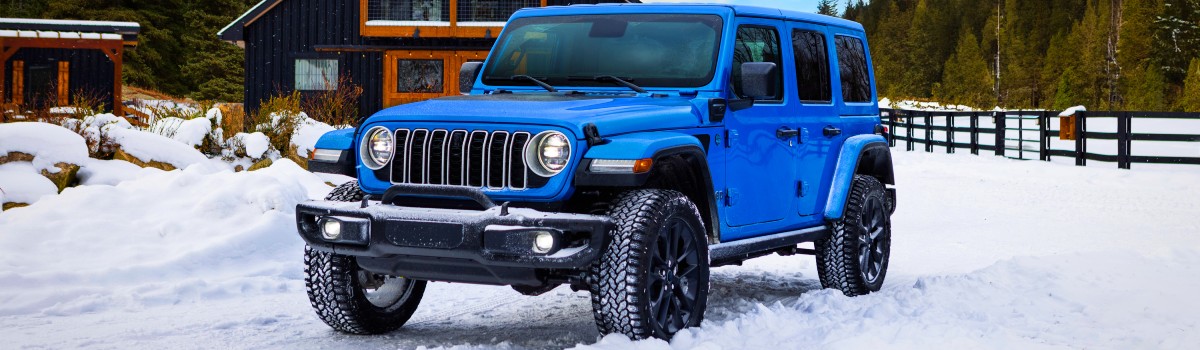 2025 Jeep Wrangler 4xe Exterior Driver Side Front Angle in Snow