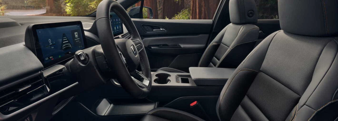 2026 Honda Prologue interior with sleek black leather seats, a modern dashboard, and a touchscreen display. The cabin feels spacious and sophisticated.