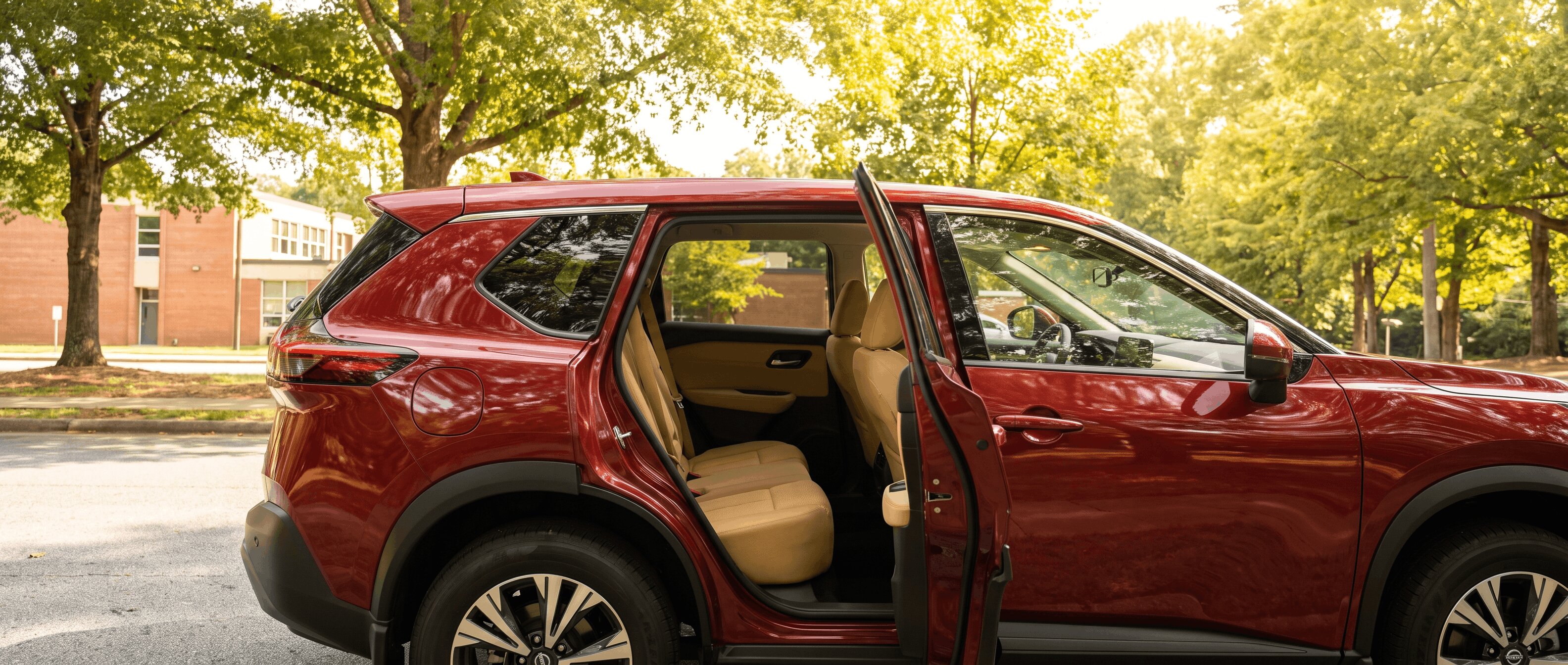 2026 Nissan Rogue rear door open wide in Roswell GA summer parking lot