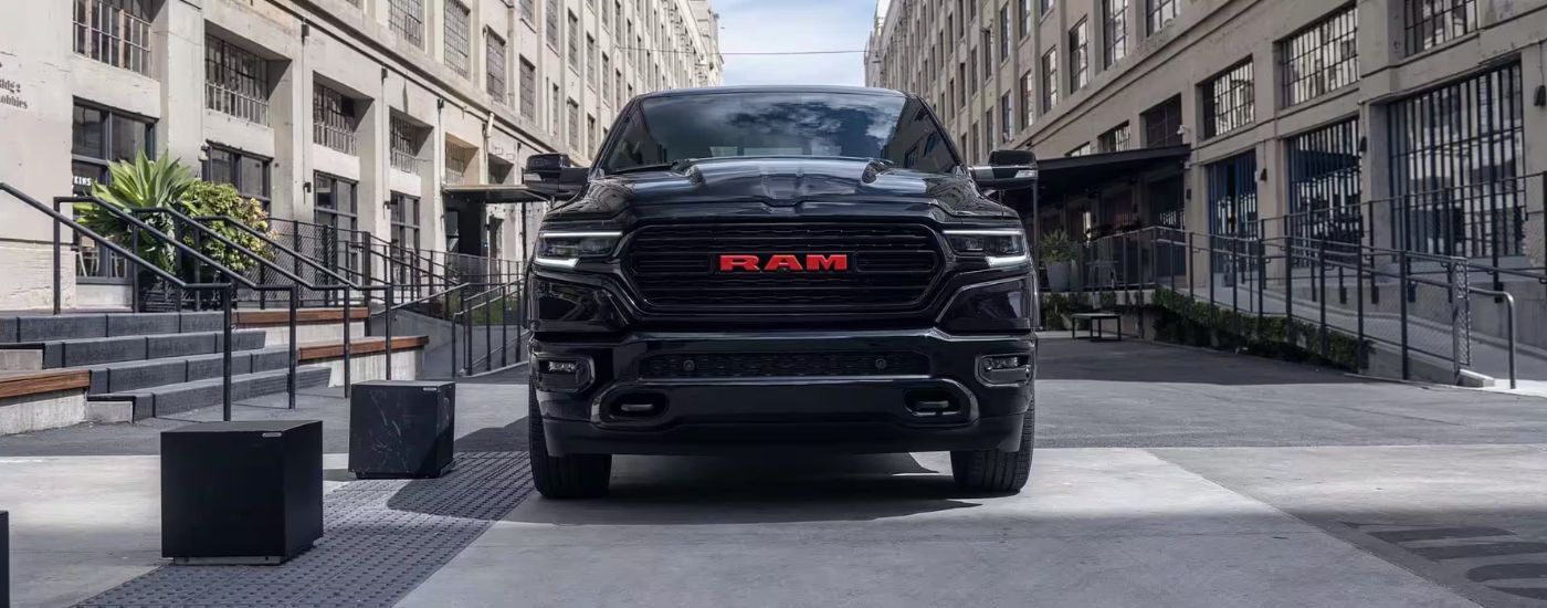 Black 2023 Ram 1500 Limited parked in a city.