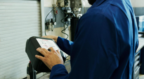 Man running a diagnostic engine service test on a toyota vehicle in Kirksville, MO.
