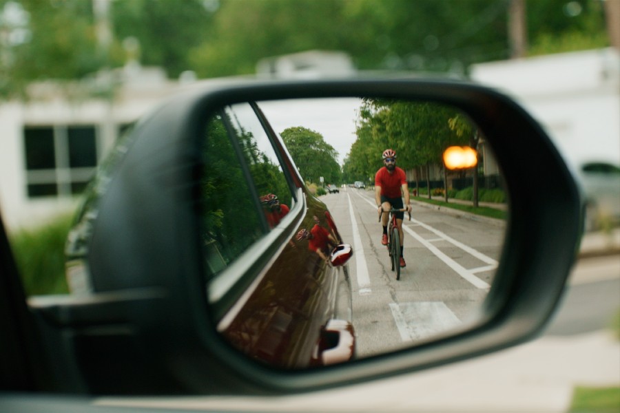 2026 Chevrolet Traverse Side Bicyclist Alert Example with Alert and Cyclist Visible in Passenger Side Mirror