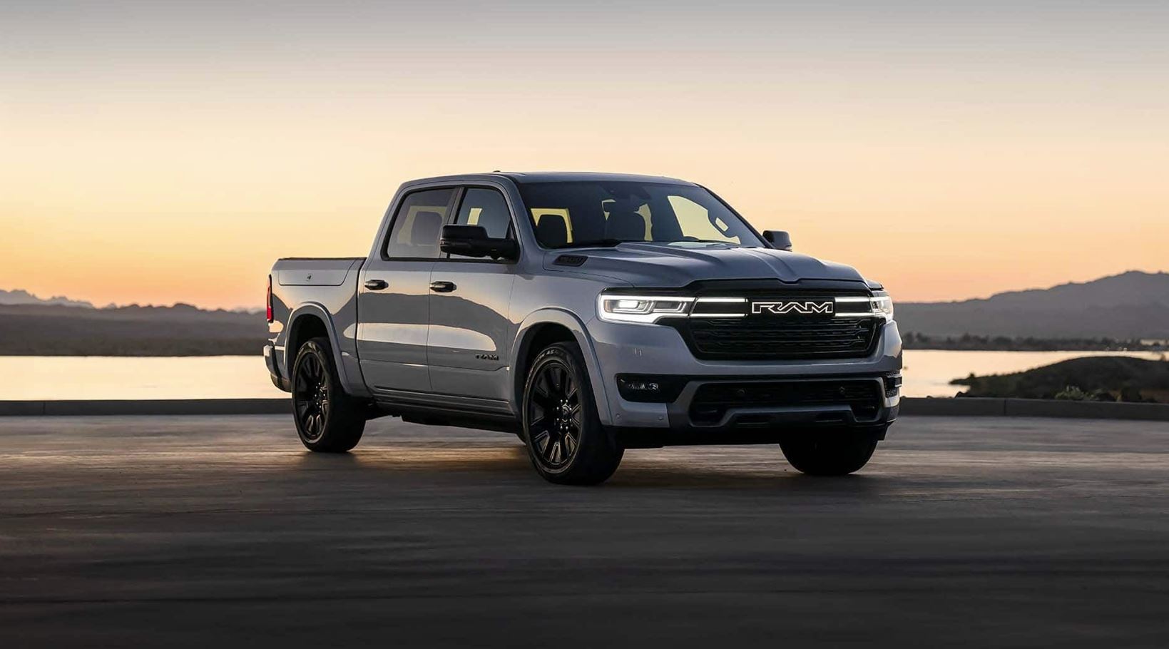 2025 Ramcharger parked on a beach at dusk with the LED headlights on