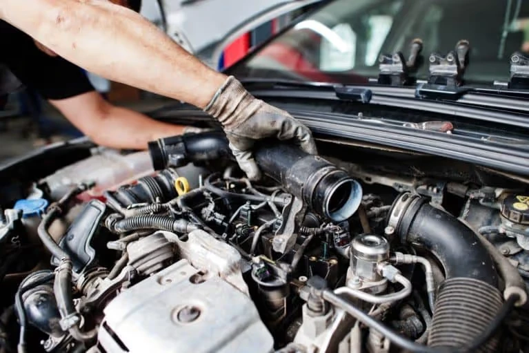 car mechanic fixing engine