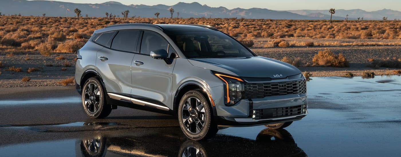Grey 2026 Kia Sportage Hybrid parked in an empty lot