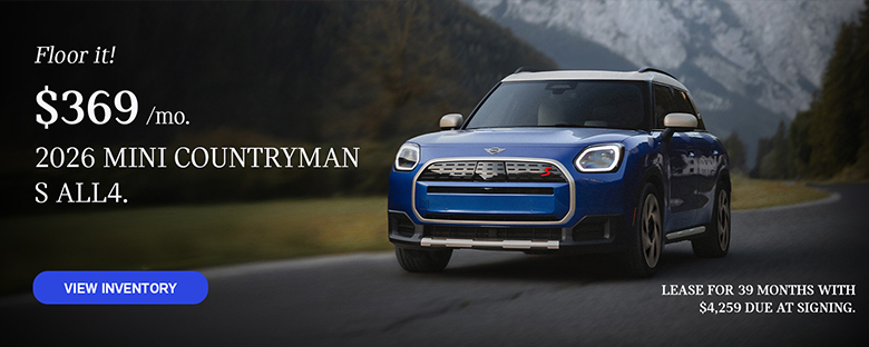 Front view of a blue MINI Countryman  driving on a mountainous road.