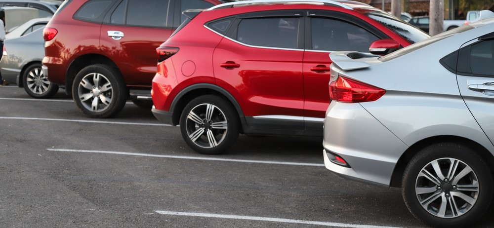 side angle view of cars lined up in diagonal parking spots