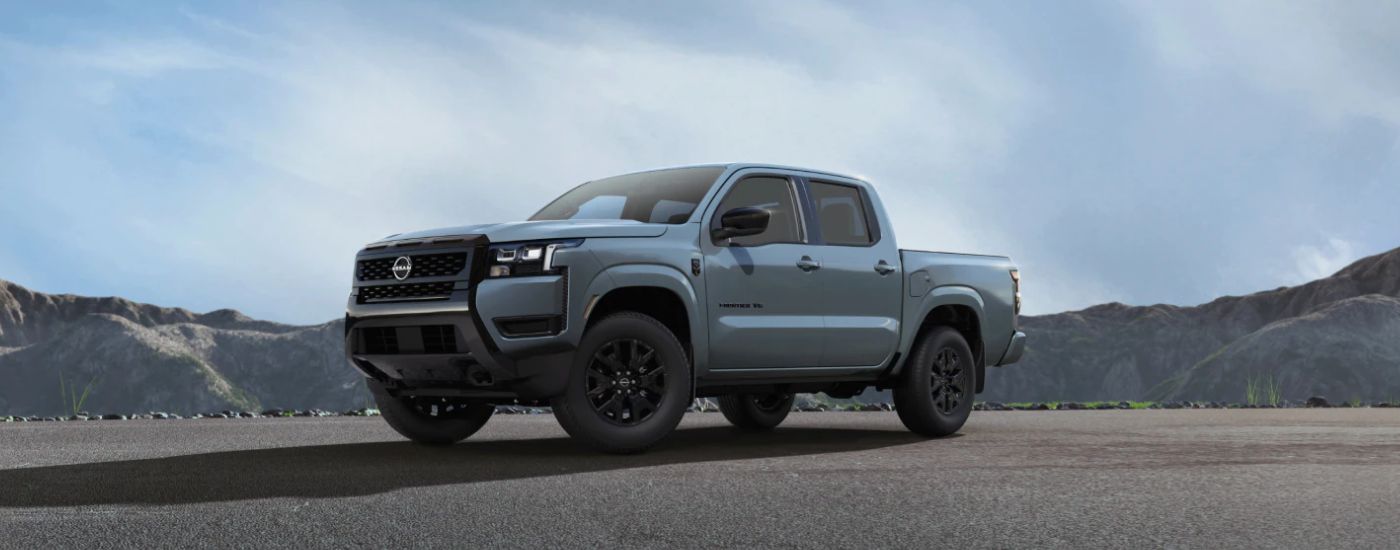 Blue 2027 Nissan Titan Dark Armor parked near the mountains.